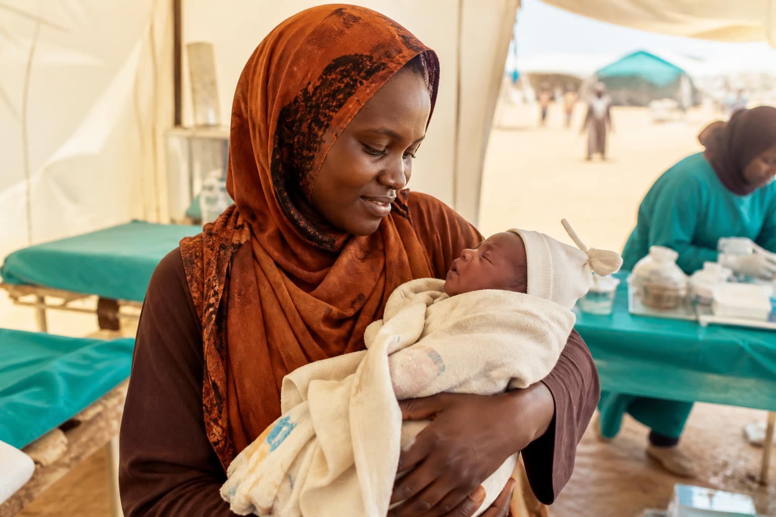 Amira holding her newborn at a Humanity Foundation field clinic in East Africa